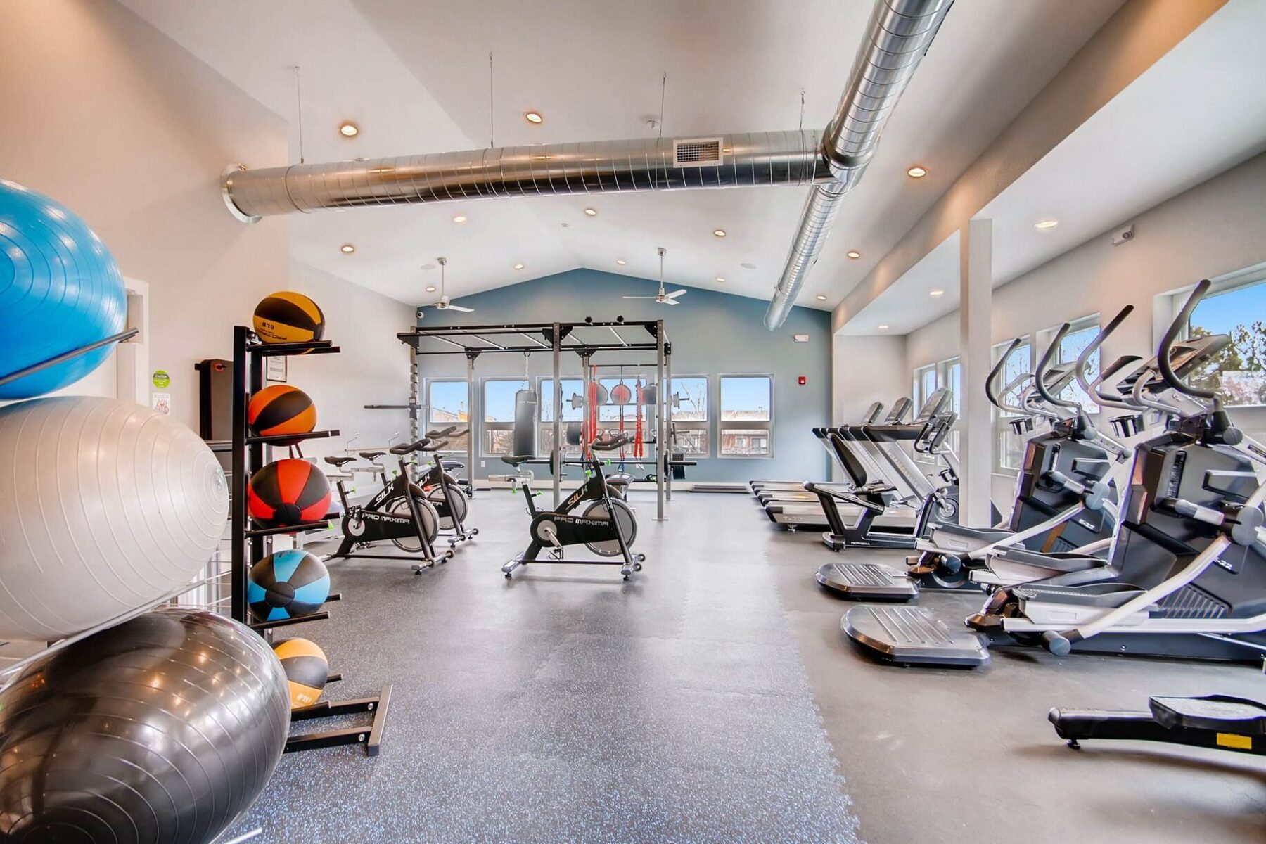 Fitness center with free weights, cardio equipment, punching bag, and yoga equipment