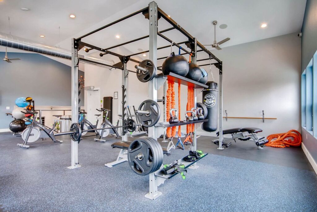 Fitness center with free weights, cardio equipment, punching bag, and yoga equipment